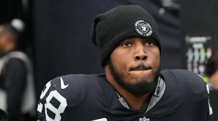 Raiders running back Josh Jacobs (28) warms up before a game against the Patriots at Allegiant Stadium.